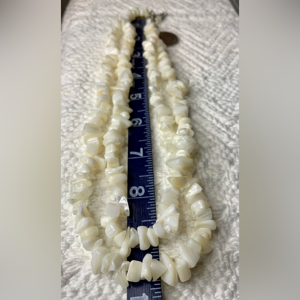 Double strand mother of pearl necklace. Approximately 9 Inches long.